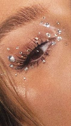 a woman's eye with glitter on it