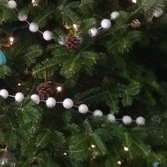 a teddy bear sitting on top of a christmas tree