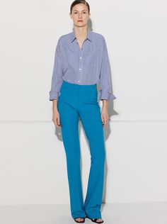 The Danae is the newest pant in the CÂLLAS pant collection. It is a high rise pant with the waistband sitting at the true waist position. It fits slim thru the hips and thighs, and from below the knees, gently flares to the hem. Based on the popular CÂLLAS Jules pant, the Danae has a long and lean flare leg silhouette tailored in a fluid crepe stretch fabric with 4-way stretch. Style, comfort, and versatility come together to create a wardrobe staple. The unique weave of the fabric makes it prac Chic Stretch Blue Flares, Blue Flare Pants For Work, Chic Blue Fitted Flares, Elegant Blue Flare Bottoms, Chic Blue Wide-leg Flares, Chic Blue Flare Wide Leg Pants, Blue Flare Pants In Elastane, Blue Flare Pants With Elastane, High-waisted Flares For Workwear