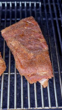 two steaks are cooking on the grill