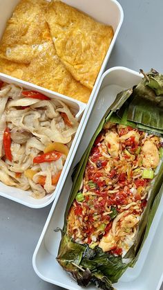 two trays filled with different types of food on top of a gray table next to each other