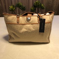 Tommy Hilfiger Signature Brown, Cream And Tan On The Go Tote! Brand New Tote Features Spacious Front Exterior Slip Pocket, Interior Front Slip Pocket, Back Wall Zip Pocket, Inside Very Spacious, Hardware Is Gold, And Drop Strap About 10in. W 14 1/2 H 10 1/2 D 5in Make Me An Offer Thank You For Stopping By Tommy Hilfiger Beige Bags, Tommy Hilfiger Beige Shoulder Bag For Everyday Use, Elegant Beige Tommy Hilfiger Bag, Elegant Tommy Hilfiger Beige Bag, Tommy Hilfiger Tote Bags, Tommy Hilfiger Bag, Tommy Hilfiger Handbags, Rose Gold Shoes, Soft Leather Tote