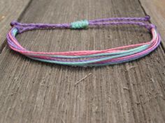 a close up of a bracelet on a wooden surface