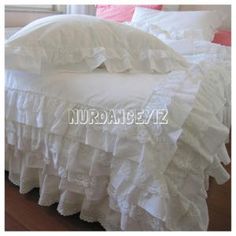 white ruffled bedspread with lace trimmings on the edges and bottom