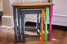 three colorful stools sitting on top of a hard wood floor