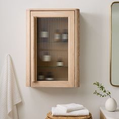 a wooden cabinet sitting on top of a bathroom counter