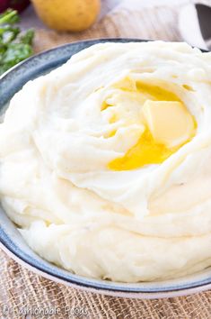 mashed potatoes with butter and parmesan cheese in a bowl on a table