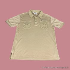 Vintage 70s Kennington California Polo Shirt! * Beige cotton polyester blend. * 1970s vintage polo shirt. * Kennington of California tag. * Short sleeve. * Metal snap closures. * Dual chest pockets with snap closures. * Third zip pocket. * Excellent condition. some light pilling. SIZE & MEASUREMENTS Tag size LARGE - FITS LIKE A MODERN MEDIUM (Check Measurements) MEASUREMENTS: Chest: 21 inches (Sleeve seam to sleeve seam) Length: 26 inches (Collar to bottom hem) To ensure a good fit, please measu