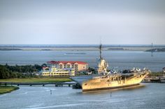 a large ship is in the water near some buildings