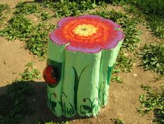 a tree stump with a flower painted on it