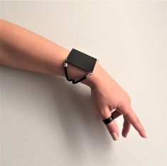 "Women's black square bracelet, black metal sharp cuff bracelet, edgy-rock style bracelet, geometric black jewelry, statement cuff, women's gift Welcome to my shop! ✈️ DHL EXPRESS SHIPPING AVAILABLE, 1-3 BUSINESS DAYS DELIVERY! ✔️ PLEASE MAKE SURE TO SELECT IT, RIGHT BEFORE YOUR PURCHASE! ❗️ ❗️ DON'T FORGET TO ADD YOUR CELL # AT THE \"NOTE TO SELLER\" SECTION IF YOU CHOOSE DHL! BY FILLING YOUR CELL NUMBER YOU EARN THE BENEFIT TO CHOOSE BETWEEN 6 DIFFERENT DELIVERY OPTIONS! INSTRUCTIONS WILL BE S Modern Black Rectangular Leather Bracelet, Edgy Black Bracelet Strap Jewelry, Edgy Black Metal Cuff Bracelet, Black Edgy Jewelry With Bracelet Strap, Edgy Black Jewelry With Bracelet Strap, Adjustable Matte Black Modern Jewelry, Modern Matte Black Adjustable Jewelry, Black Metal Cuff Bracelet, Black Metal Minimalist Cuff Bracelet