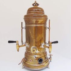 an old fashioned coffee grinder sitting on top of a table