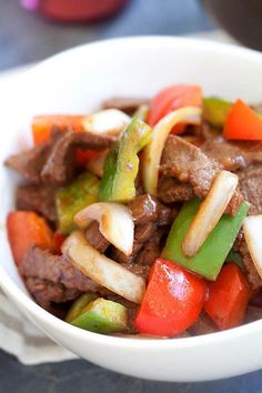 a close up of a bowl of food with meat and vegetables