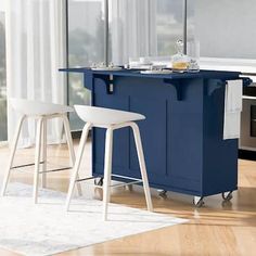 a kitchen island with two stools next to it