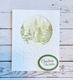 a christmas card with trees and the words christmas wishes written in green ink on white paper