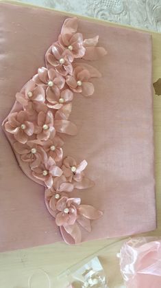 a piece of pink fabric with flowers on it