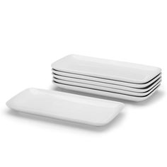 four white plates stacked on top of each other