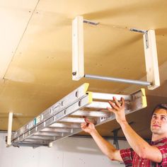 a man working on a metal ladder in a garage