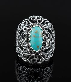 This oxidized 925 sterling silver lace detailed women ring feature with Malachite, Turquoise, Chalcedony, Blue Quartz, Carnelian and Black Onyx Gemstones. This unique designed, intricate ornamented bold ring has size 5 to 12.5 with half sizes. One of them will be your favorite gift option for thanksgiving, anniversary, birthday or mother`s day for yourself or your loved one.  The natural Malachite, Black Onyx, Rhodonite and Carnelian gemstones are 7x14 mm cabochon oval-cut. Chalcedony and Blue Quartz gemstones are double side faceted, checkerboard oval-cut. The Malachite gemstone is also known April and May Birthstone, Rhodonite which is pinky in color is one of the natural birthstones of those born in the October.  The Ring Face Length is 0.65 inches and Width is 0.30 inches  Comes with a Filigree Rings, The Ring Face, Bold Rings, Ring Turquoise, Silver Lace, Statement Ring Silver, Sterling Silver Filigree, Blue Quartz, Women Ring