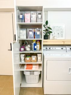 a white washer and dryer sitting next to each other in a laundry room