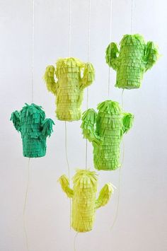 four green and yellow paper cactus mobiles hanging from strings