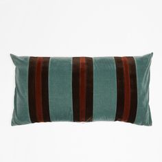 a green and brown striped pillow on a white background