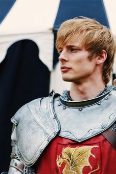 a young man dressed as a knight in armor