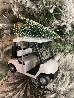 a golf cart ornament hanging from a christmas tree