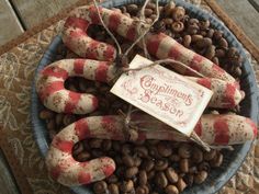 a bowl filled with candy canes on top of a table