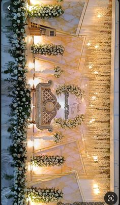 an overhead view of a wedding ceremony with white flowers and candles on the sidelines