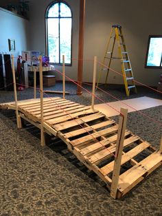 a bed frame made out of wooden pallets with ropes attached to the top and bottom