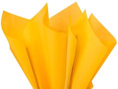 a bunch of yellow tissue paper sitting on top of each other in front of a white background