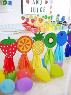 an assortment of fruit themed party decorations