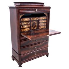 an old fashioned wooden desk with drawers on it's sides and gold trimmings