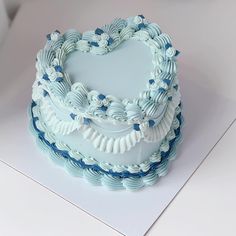 a heart shaped cake sitting on top of a table