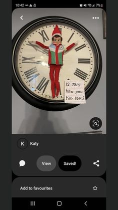 a clock with an elf on it and the words k is for how did you know?