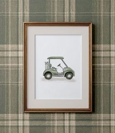 a drawing of a golf cart is hanging on the wall next to a plaid wall