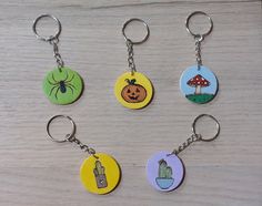 six different key chains with pictures of pumpkins, cacti and cactus on them