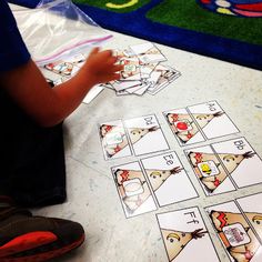 a child playing with matching cards on the floor