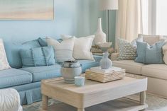 a living room filled with lots of furniture and pillows on top of a coffee table