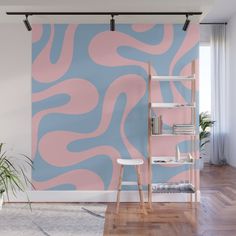 a pink and blue wall mural in a living room with a ladder to the ceiling