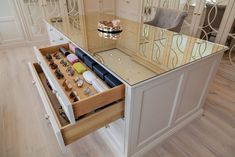 an open drawer in the middle of a kitchen