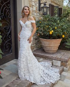 a woman in a wedding dress standing on steps