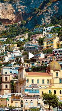 an image of a city that is on the side of a hill with mountains in the background