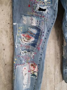 an old pair of jeans with holes and stars on them