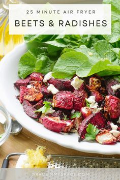 beets and radishes on a plate with spinach leaves in the background