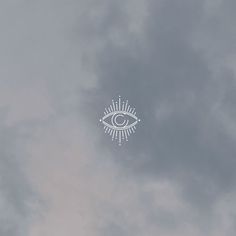 an all seeing eye in the sky on a cloudy day