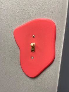 a red light switch on a white wall