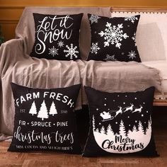 three christmas pillows on a couch with snowflakes and santa's sleigh