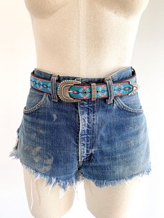 Happy and colorful cloth belt with silver tone buckle. Graphic imagery inspired by the Southwest. Fit 28.5-32.5"1 1/4” wide Era: 1980/90's Condition: Excellent Southwestern Style Concho Belt For Festivals, Southwestern Embroidered Adjustable Belt, Southwestern Adjustable Embroidered Belt, Southwestern Style Adjustable Embroidered Belt, Vintage Adjustable Turquoise Belt, Adjustable Turquoise Vintage Belt, Adjustable Vintage Turquoise Belt, Vintage Adjustable Multicolor Belts, Vintage Embroidered Belt For Rodeo